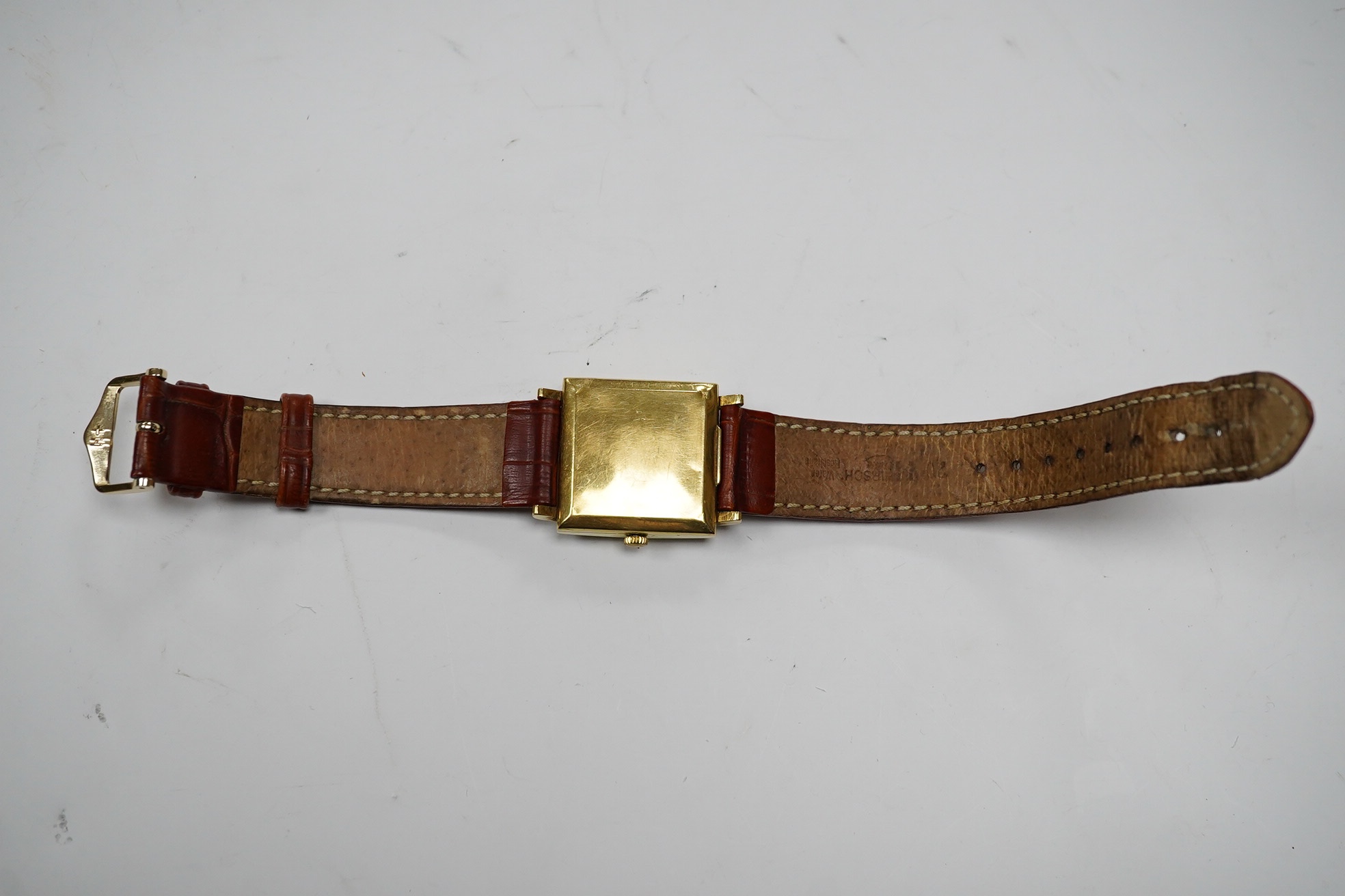 A gentleman's 18k Zenith Automatic square dial wrist watch, with baton numerals and date aperture, on an associated leather strap, case diameter 30mm. Condition - poor.